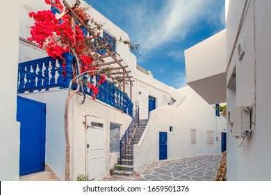 Amazing narrow streets of popular destination on Paros island. Greece. Traditional architecture and colors of mediterranean city. Blue doors, white buildings and bougainvillea flowers in paradise - Shutterstock ID 1659501376