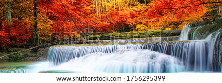 Amazing in nature, beautiful waterfall at colorful autumn forest in fall season, autumn wonderful mood.