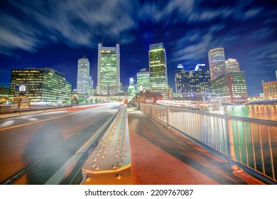 Amazing Night Colors Of Boston Waterfront. City Skyline From The Bridge.