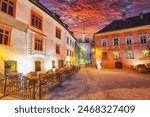 Amazing night view of historic town Sighisoara and Clock Tower built by Saxons. Popular travel destination. Location: Sighisoara, Mures county, Romania, Europe