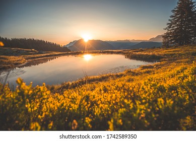 Amazing panorama of French Alps, part of famous trek Chamonix Mont Blanc in the backround.. View of French mountains in summer hiking. Sunrise on the lake