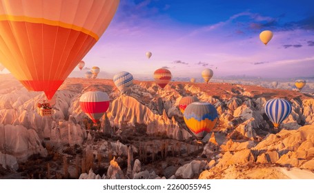 Amazing Panoramic view sunrise rocky landscape in Cappadocia with colorful hot air balloon deep canyons, valleys. Concept banner travel Turkey. - Shutterstock ID 2260055945