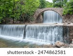 Amazing picture with the picturesque old stone bridge at Palaiokarya waterfalls near Trikala in Greece.