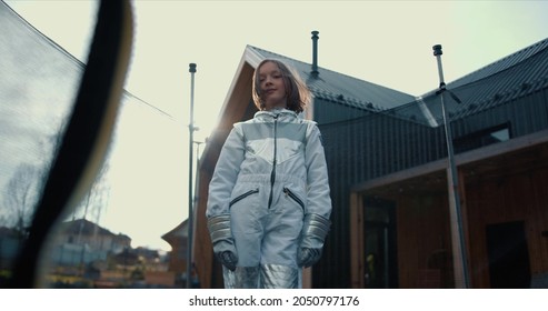 Amazing Portrait, Beautiful Confident Teen Age Girl With Hair Blowing In Wind Looks At Camera In White Astronaut Suit.