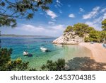 Amazing Punta Rata beach with boats against azure sea in Brela, Makarska, Dalmatia, Croatian azure coast