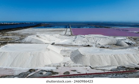 Amazing salt mountain, salt deposit of the Saline de Giraud in Provence in the Camargue Regional Natural Park France. wonders of the Mediterranean and Provence on a sunny day. tourist half for a trip - Powered by Shutterstock