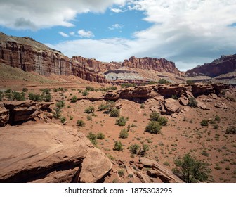 Amazing Sandstone Monoliths In A Barren Desert Prairie On A Blue Partly Cloudy Summer Day At Capitol Reef National Park In Torrey Utah