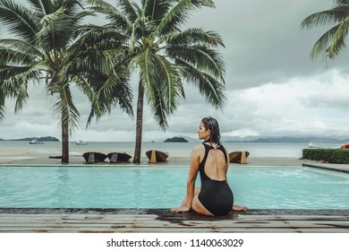 Amazing Scenic Rear View Of Sexy Young Woman Relaxing On The Pool Of Luxury Hotel Against Summer Holidays Vacation, Tropical Beach On The Island