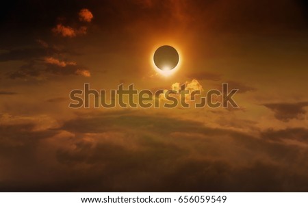 Amazing scientific background - total solar eclipse in dark red glowing sky, mysterious natural phenomenon when Moon passes between planet Earth and Sun
