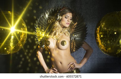 amazing sexy woman dances in a sparkling gold costume