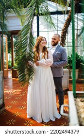 Amazing Smiling Redhead Wedding Couple. Pretty Bride And Stylish Groom In The Botanical Garden.