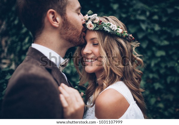 Amazing smiling wedding couple. Pretty bride and stylish groom.