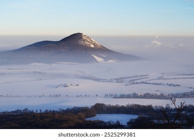 Amazing spectatcular winter foggy misty morning in Czech Central Mountains, snowy landscape hills above gray layer of inversion and smog pollution - Powered by Shutterstock