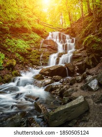 Amazing sunny summer landscape with beautiful Shypit waterfall in Carpathian mountains, popular tourist attraction, nature travel background suitable for wallpaper or cover, vertical image