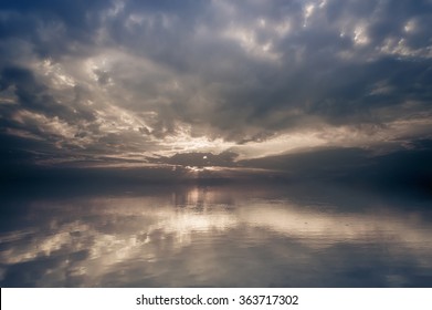 Amazing sunrise landscape. Calm lake water with clouds reflection