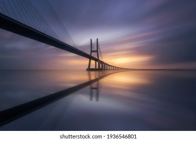 Amazing sunrise in Lisbon, watching the Vasco da Gama Bridge start to light up - Shutterstock ID 1936546801
