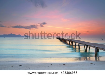 amazing sunrise at wooden Pier on the beach                                       