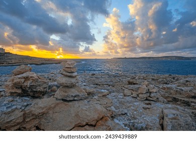 Amazing sunset  with clouds and meditterranean sea on the north of Malta, near the Coral Lagoon