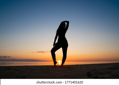 Amazing Sunset. Female Siluet On The Sunset Background. People On The Image - Unrecognizable.  Orange Sunset - Golden Hour During Estonian Mid Summer Fest. Darker Images With High Resolution
