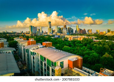 Amazing Sunset Over Modern Condo Towers and Growing Cityscape of Austin Texas USA by Drone during golden hour sunset with amazing large cumulus cloud growing behind the downtown Skyline