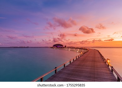 Amazing sunset panorama at Maldives. Luxury resort villas seascape with soft led lights under colorful sky. Beautiful twilight sky and colorful clouds. Beautiful beach background for vacation holiday - Powered by Shutterstock