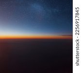 Amazing sunset in the sky with stars and clouds. Photo from the plane. Travel and flight concept