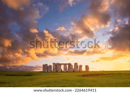 Amazing sunset at Stonehenge in England with dramatic sky and sun rays