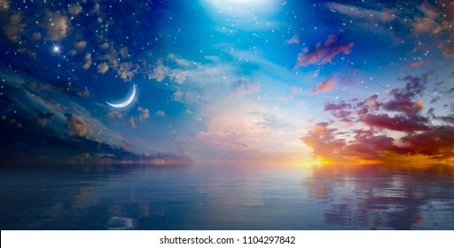 Amazing surreal background - crescent moon rising above serene sea in sunset sky, glowing horizon and bright stars.  Elements of this image furnished by NASA