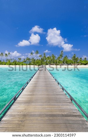 Amazing travel landscape concept. Beautiful best tropical Maldives island and wooden pier pathway. Sunny beach sea bay coconut palm trees on blue sky for nature holiday vacation panoramic wallpaper
