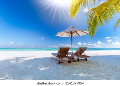 Amazing tropical landscape- Summer scene with lounge chairs and palm trees on white sandy beach background with sea view - Shutterstock ID 1141397354