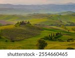 Amazing Tuscany panoramic landscape with green rolling hills with trees in spring, Italy.