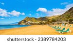 Amazing view of beach las Teresitas with yellow sand, umbrellas, longues and palm trees. Location: Santa Cruz de Tenerife, Tenerife, Canary Islands. Artistic picture. Beauty world.