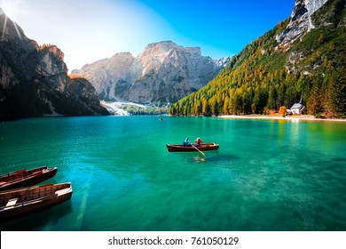 amazing view of braies lake with wooden boats on the water, surrounded by dolomites mountains. Trentino alto adige, Italy