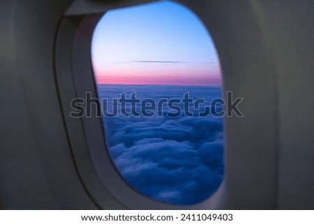 Amazing view of clouds and sunset in window on an airplane. 
