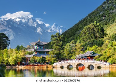 Amazing view of the Jade Dragon Snow Mountain and the Suocui Bridge over the Black Dragon Pool in the Jade Spring Park, Lijiang, Yunnan province, China.