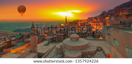 Amazing view of Mardin castle in old town on the background spectacular Mesopotamia at sunset - Mardin, Turkey