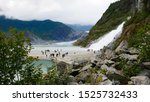 Amazing view of Mendenhall Glacier and Nugget Falls located in Mendenhall Valley near Juneau, Alaska. Blurred people as background