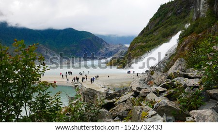 Amazing view of Mendenhall Glacier and Nugget Falls located in Mendenhall Valley near Juneau, Alaska. Blurred people as background