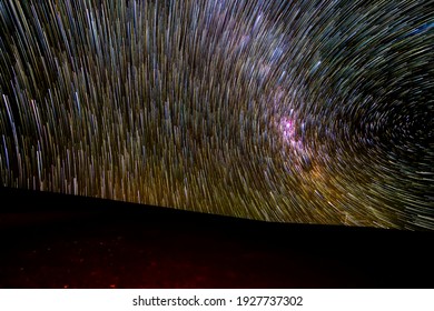 An Amazing View Of The Milky Way Rising In Atacama Desert Night Sky While The Moon Sets. An Awe View Of The Stars And All The Artificial Satellites Space Traffic As Moving Stars Above The Desert Field