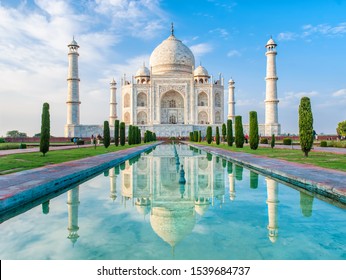 Amazing view on the Taj Mahal in sunset light with reflection in water. The Taj Mahal is an ivory-white marble mausoleum on the south bank of the Yamuna river. Agra, Uttar Pradesh, India. 