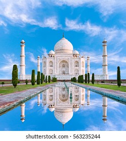 Amazing view on the Taj Mahal in sun light with reflection in water. The Taj Mahal is an ivory-white marble mausoleum on the south bank of the Yamuna river. Agra, Uttar Pradesh, India.