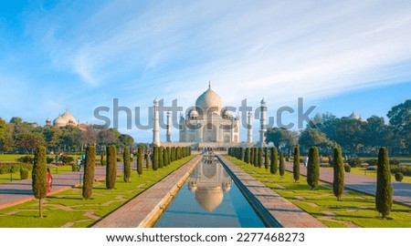 Amazing view on the Taj Mahal with reflection in water at sunny day - Agra, Uttar Pradesh, India