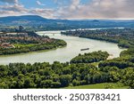 Amazing view over Danube river, aerial shot from Danube river and trees landscape. Panorama of Esztergom valley with ship on Danube river. Discover the beauties of Hungary.