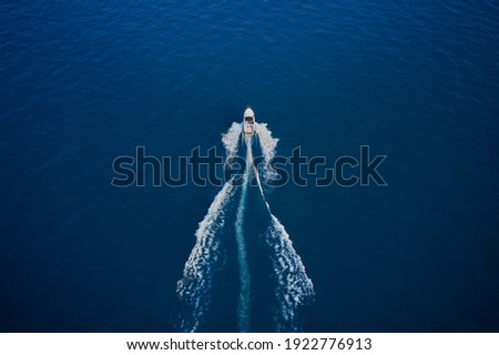 Amazing view to yacht. Aerial view of luxury floating ship at sunset, blue sea. High altitude air view. Yacht at the sea in Europe.
