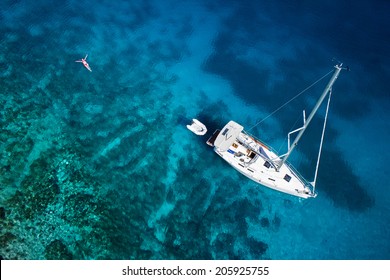 amazing view to yacht, swimming woman and clear water caribbean paradise