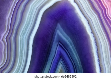 Amazing Violet Agate Crystal cross section. Natural translucent agate crystal surface, Purple abstract structure slice mineral stone macro closeup