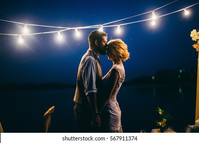 Amazing wedding couple near the river at night 