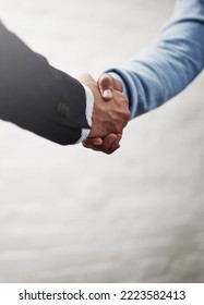 Its Amazing What We Can Achieve When We Come Together. Cropped Shot Of Two Businesspeople Shaking Hands.