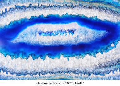 Amazing white blue Agate Crystal cross section. Natural translucent agate crystal surface, Blue abstract structure slice mineral stone macro closeup. Beautiful unique detail texture of blue stone