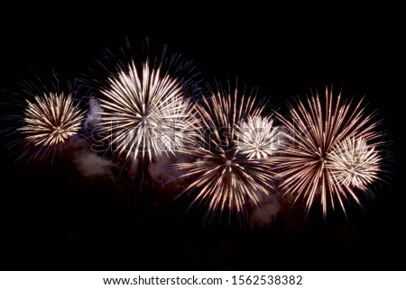 Amazing white and blue fireworks on dark background. Flashes of fireworks of green color